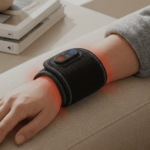 Person using a black wristband with a red light on a beige surface
